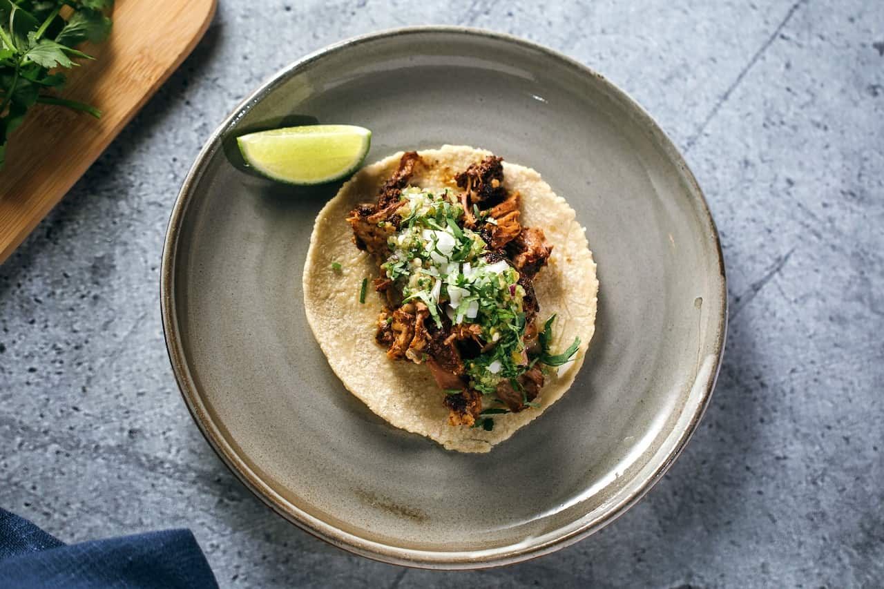 Lamb barbacoa with consomé, salsa verde and tortillas