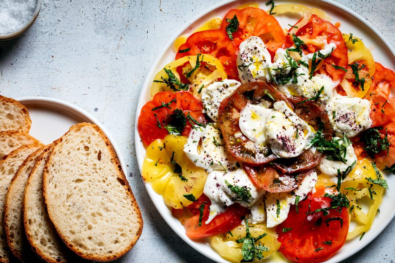 Heirloom tomato, mozzarella and basil salad with sourdough.