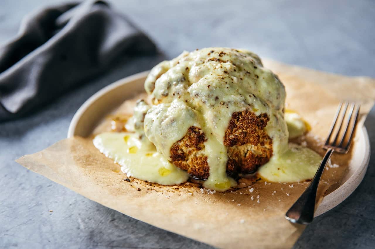 Roast cauliflower with zucchini cheese sauce