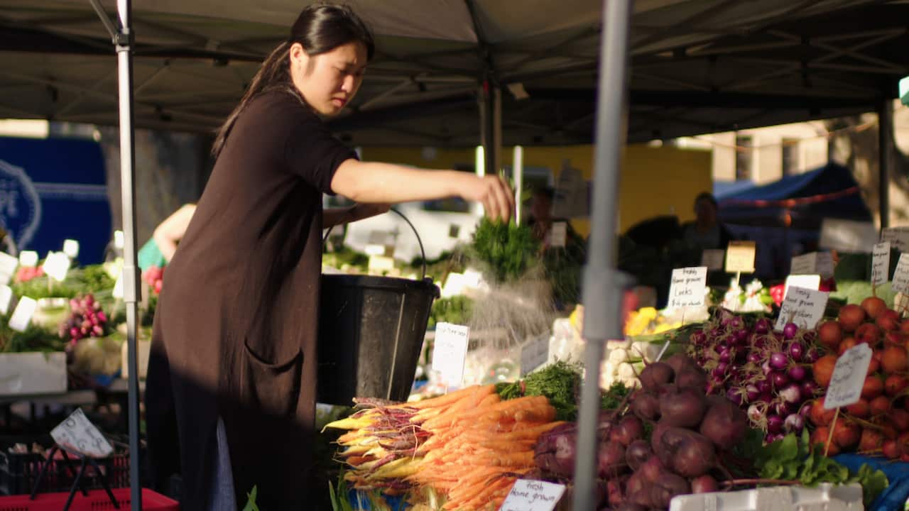 Wetting vegetables at the Salamanca Market, Hobart