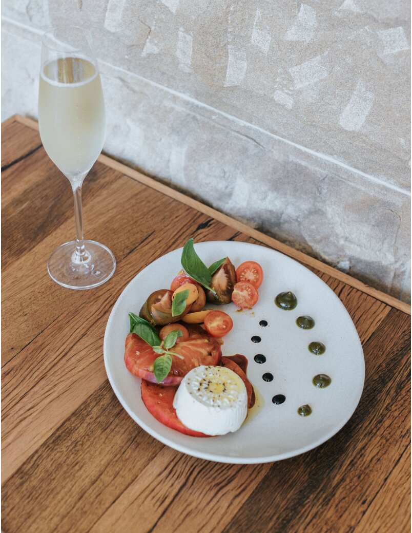A Caprese salad with a Maltese twist, served by Joseph Spiteri at Waterline by the Bay: ġbejna, heirloom tomatoes, basil and pistachio pesto.