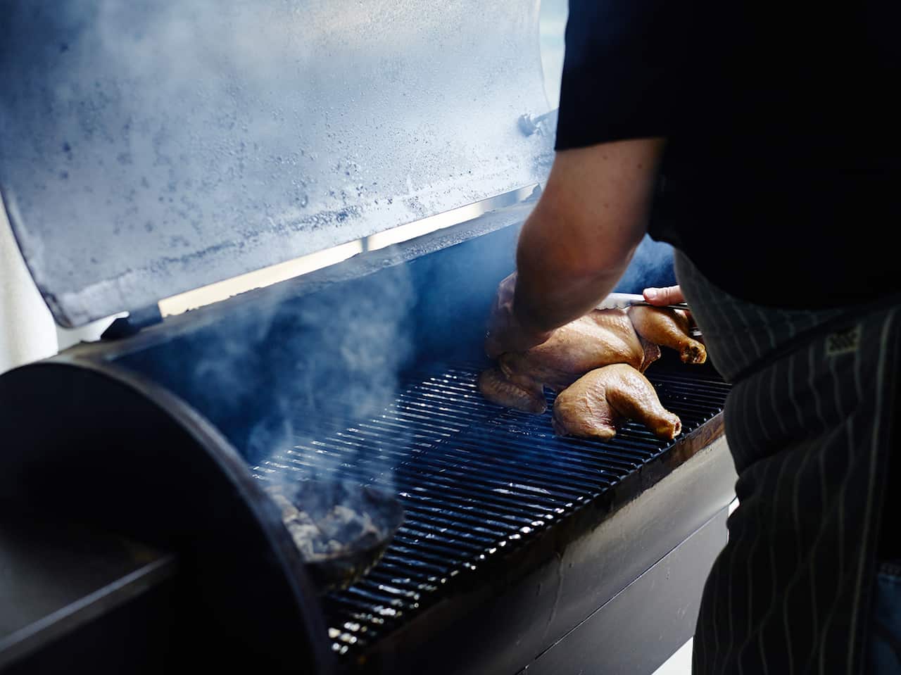 Chicken cooking on a smoker