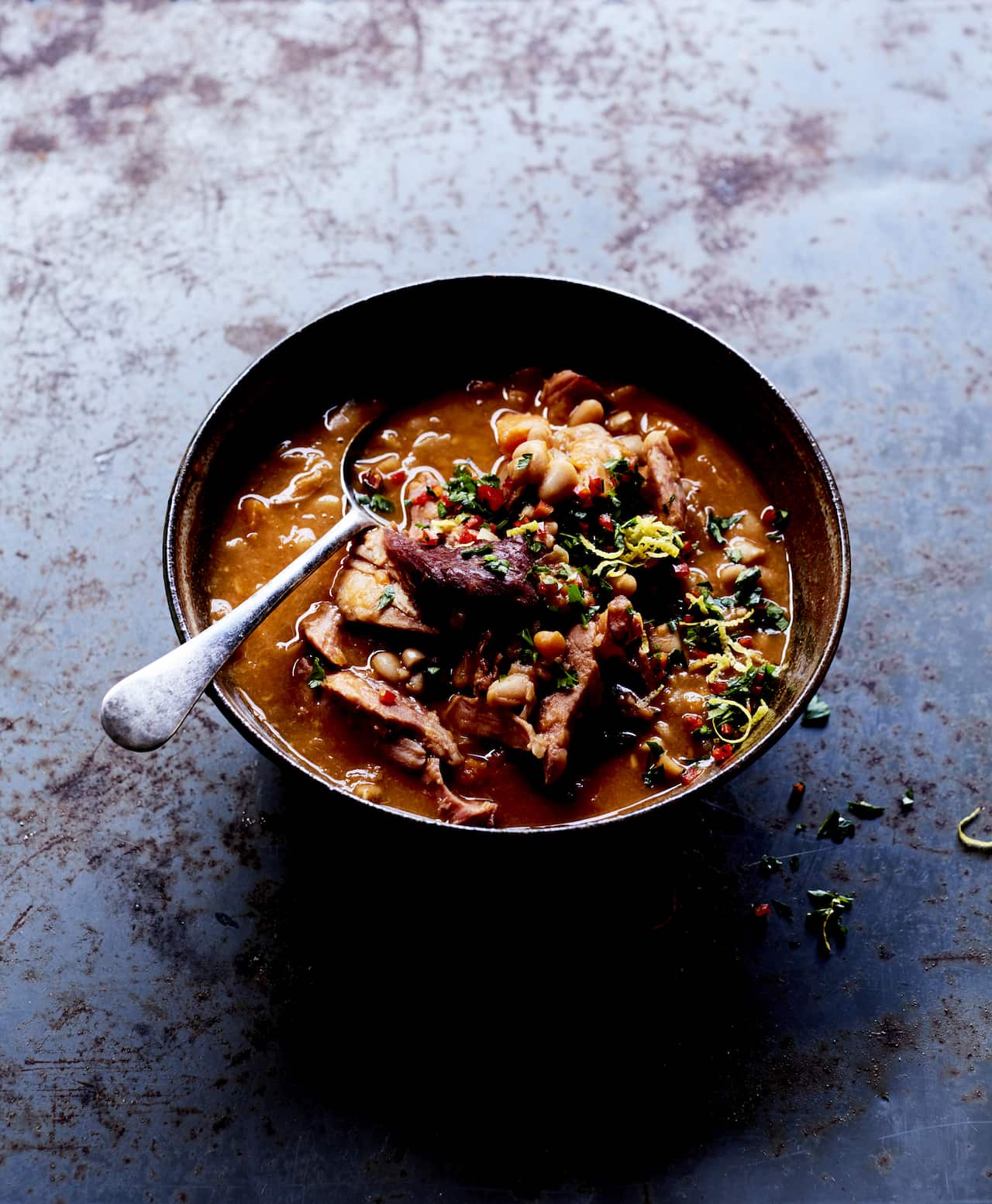 Smoky white bean, ham hock soup with gremolata.