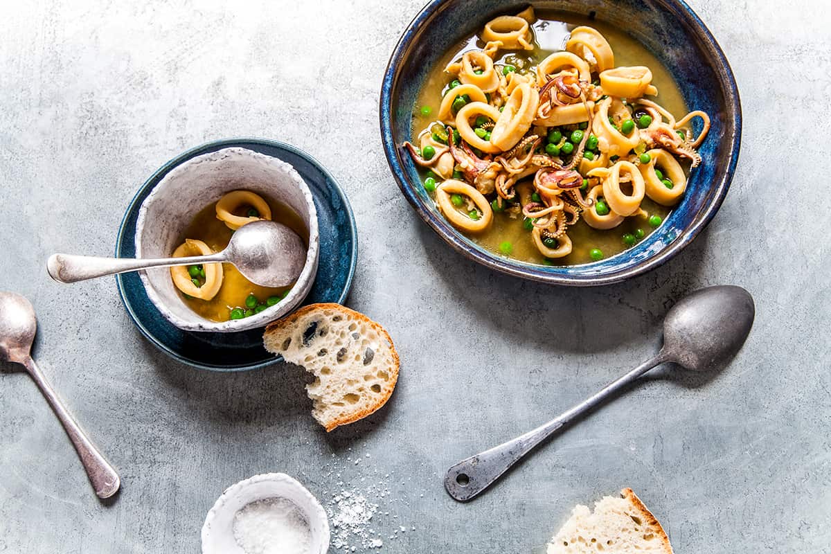 Squid braised with anchovies, saffron and peas