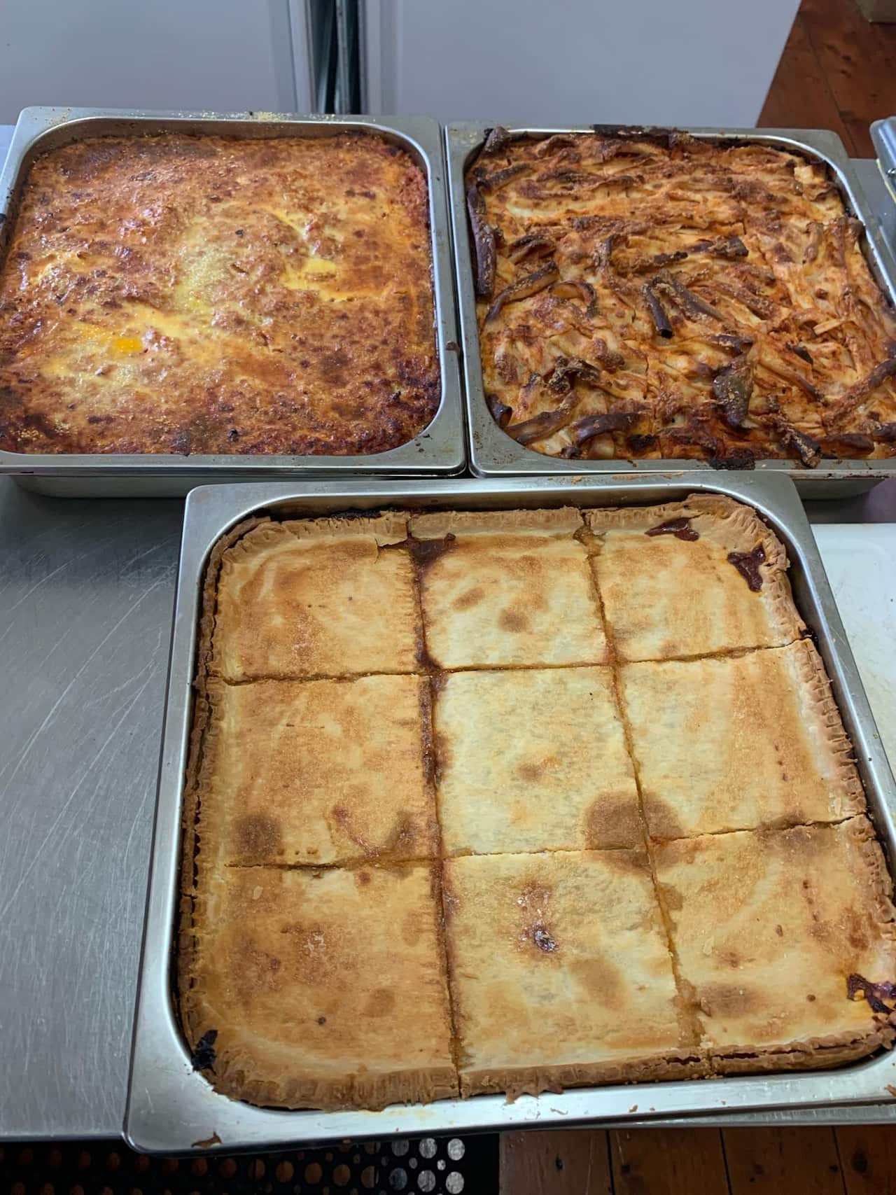 Timpana (front) is a traditional Maltese pasta pie, usually presented alongside ross il forn (back left) and ghagin il-forn (back right) at family gatherings.