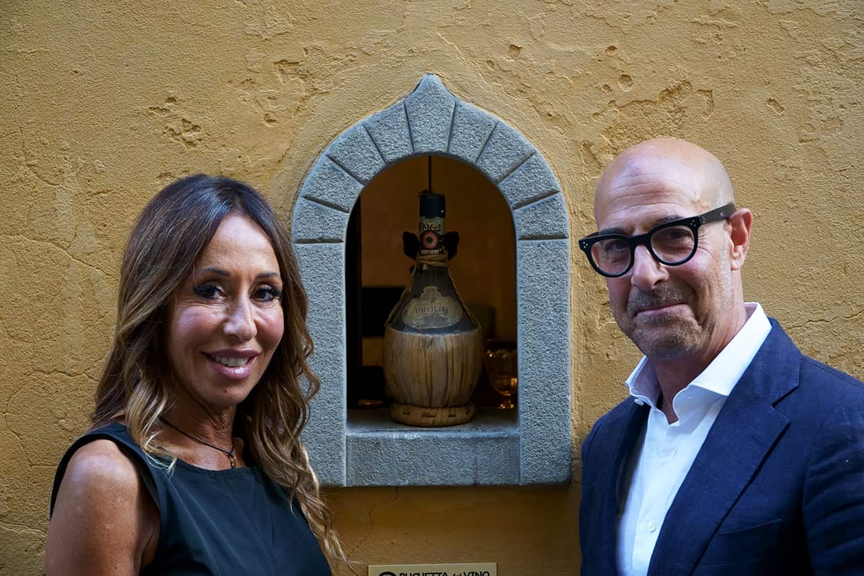 Stanley Tucci and Elisabetta di Giugno at a wine window, Florence
