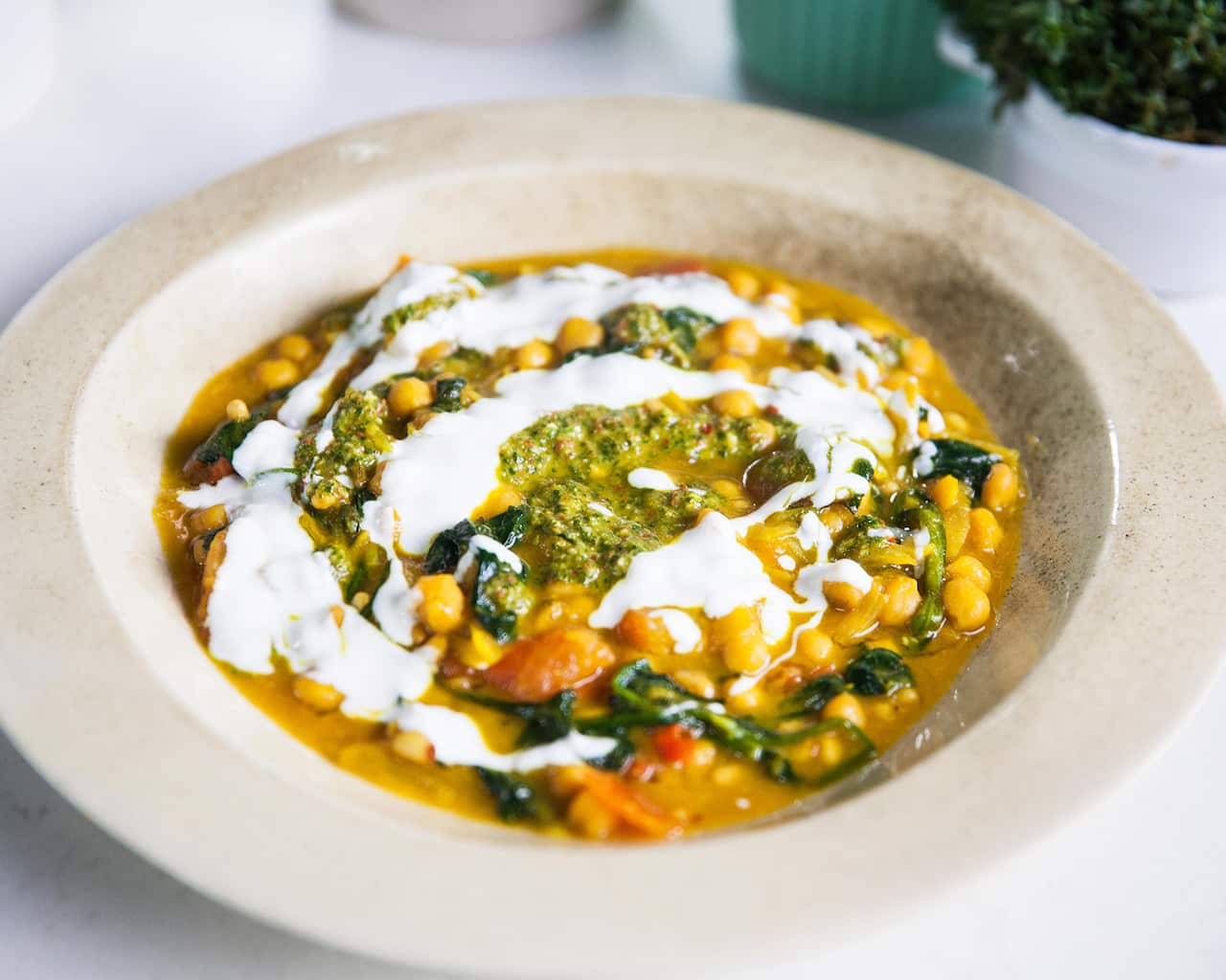 Turmeric chickpeas with tomatoes, greens and zhough