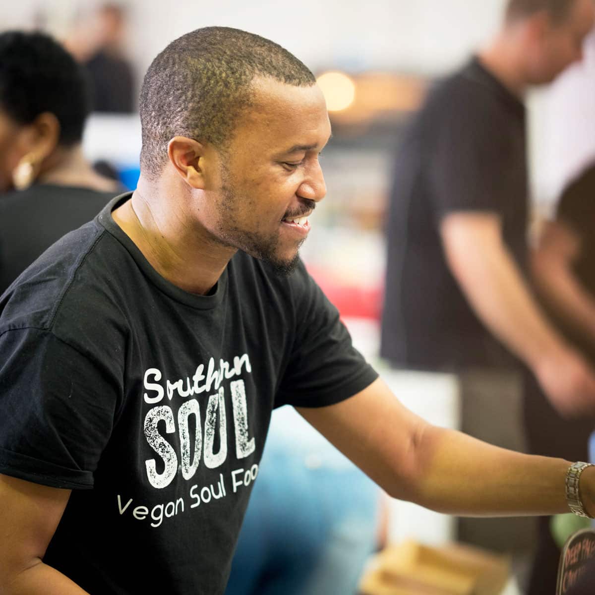 Tyree Barnette, co-owner of Southern Soul (a vegan food business), serving plant-based mac and cheese.
