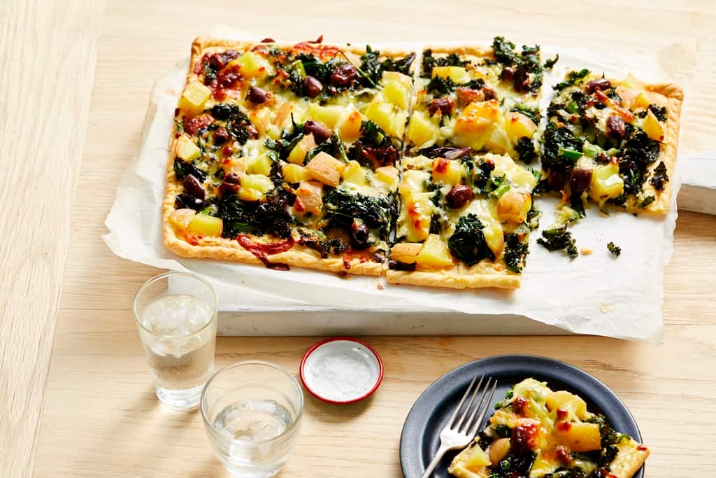 Wilted greens, potato and mozzarella tart