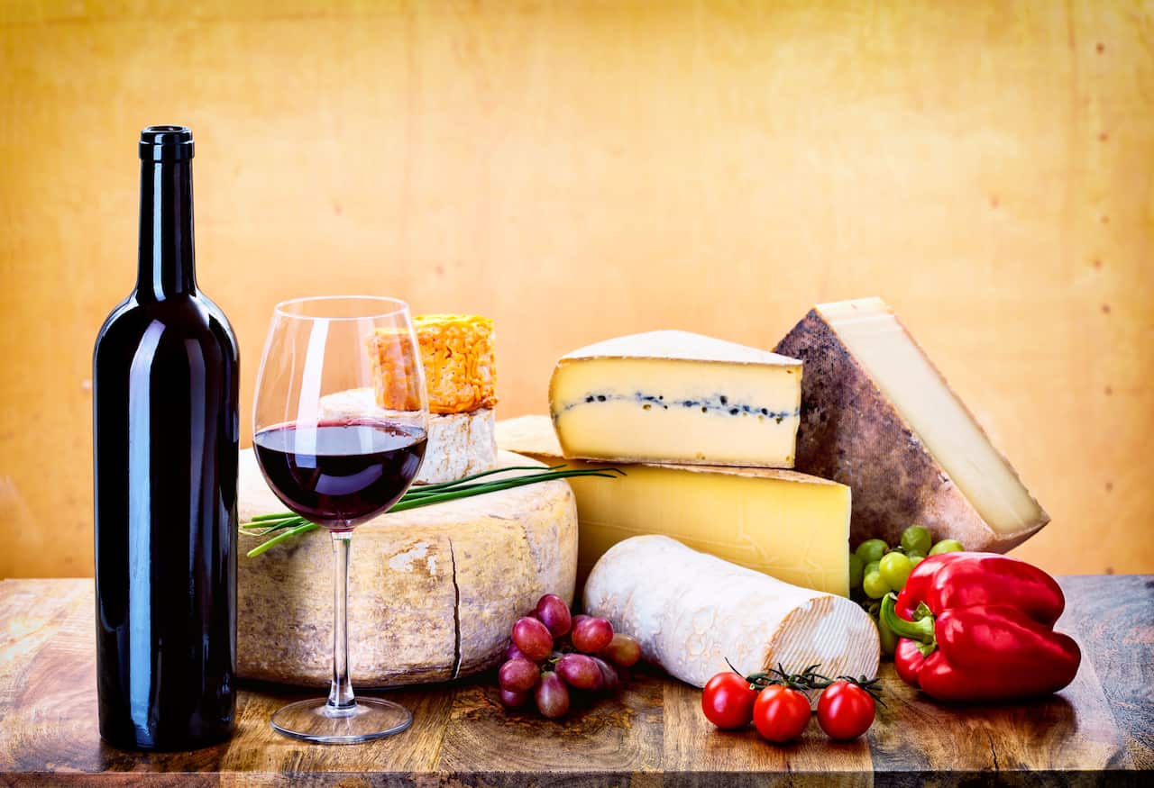 Red wine and mixed cheese platter.