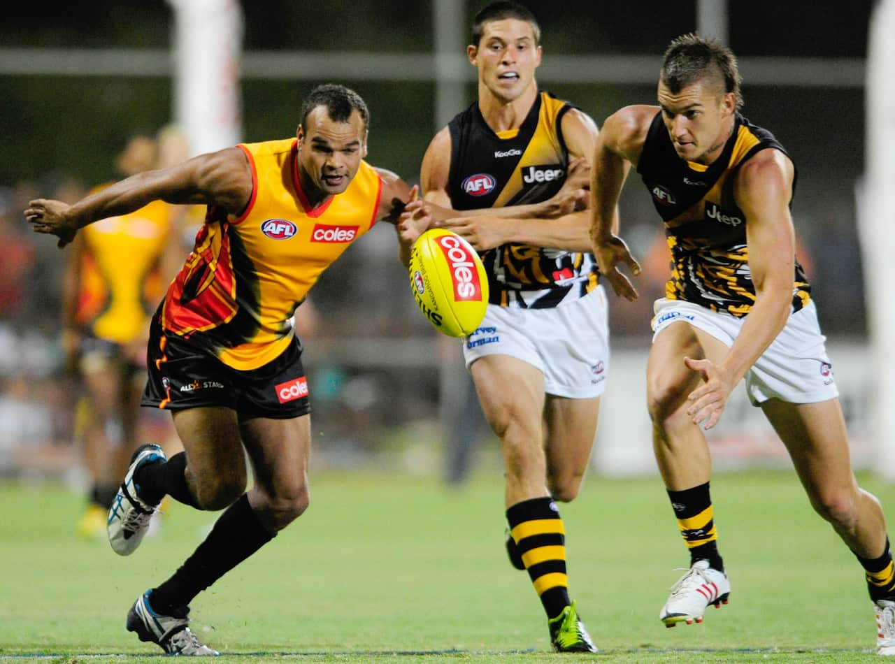 All Stars player Eddie Betts and Richmonds Dustin Martin compete for the ball during the AFL pre-season match between the Indigenous All Stars and Richmond in Alice Springs, Friday, Feb. 8, 2013. (AAP Image) NO ARCHIVING, EDITORIAL USE ONLY
