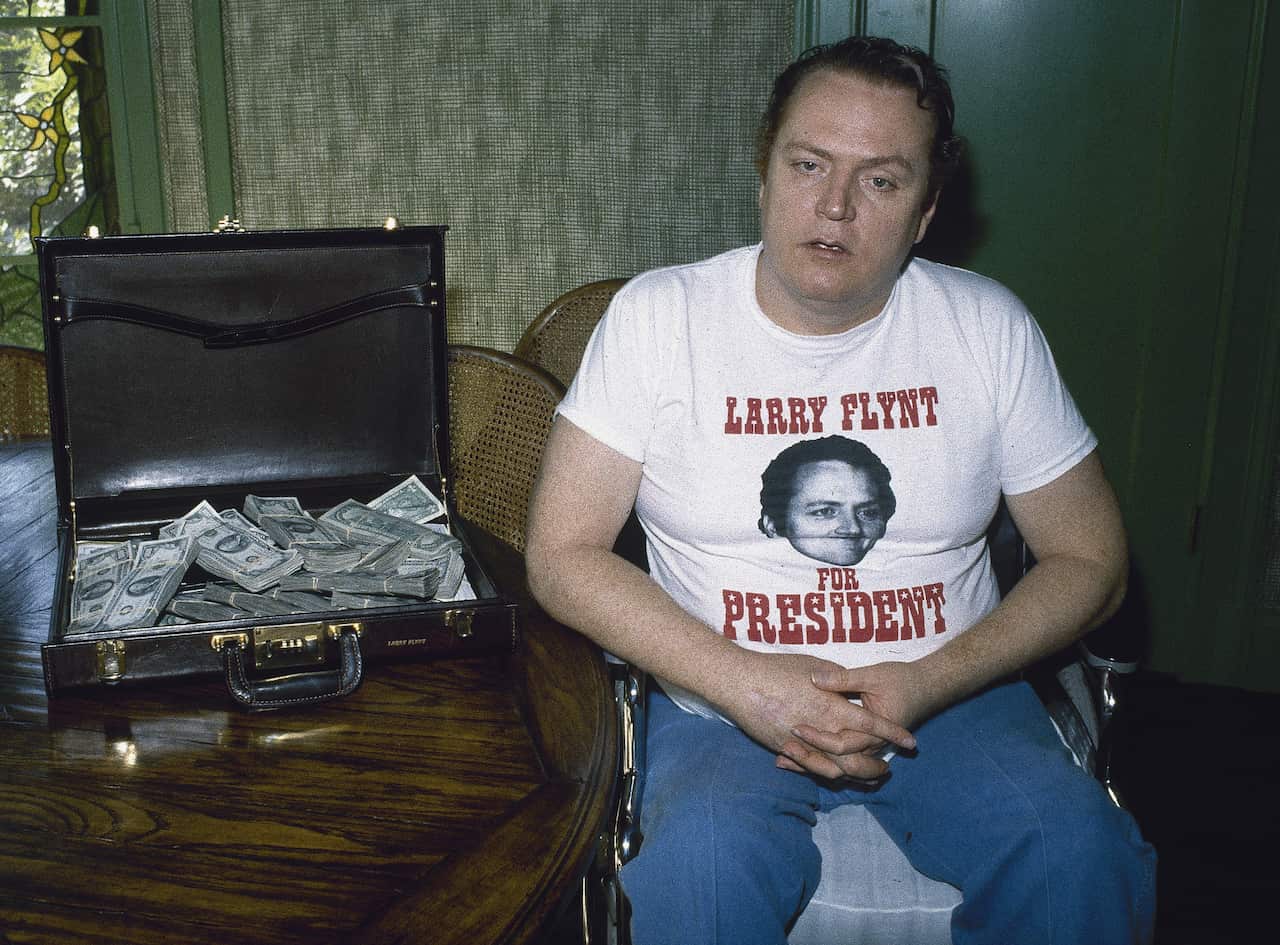 Publisher of Hustler magazine Larry Flynt is seen in Los Angeles with a briefcase full of cash, Oct. 27, 1983.  (AP Photo/Wally Fong)