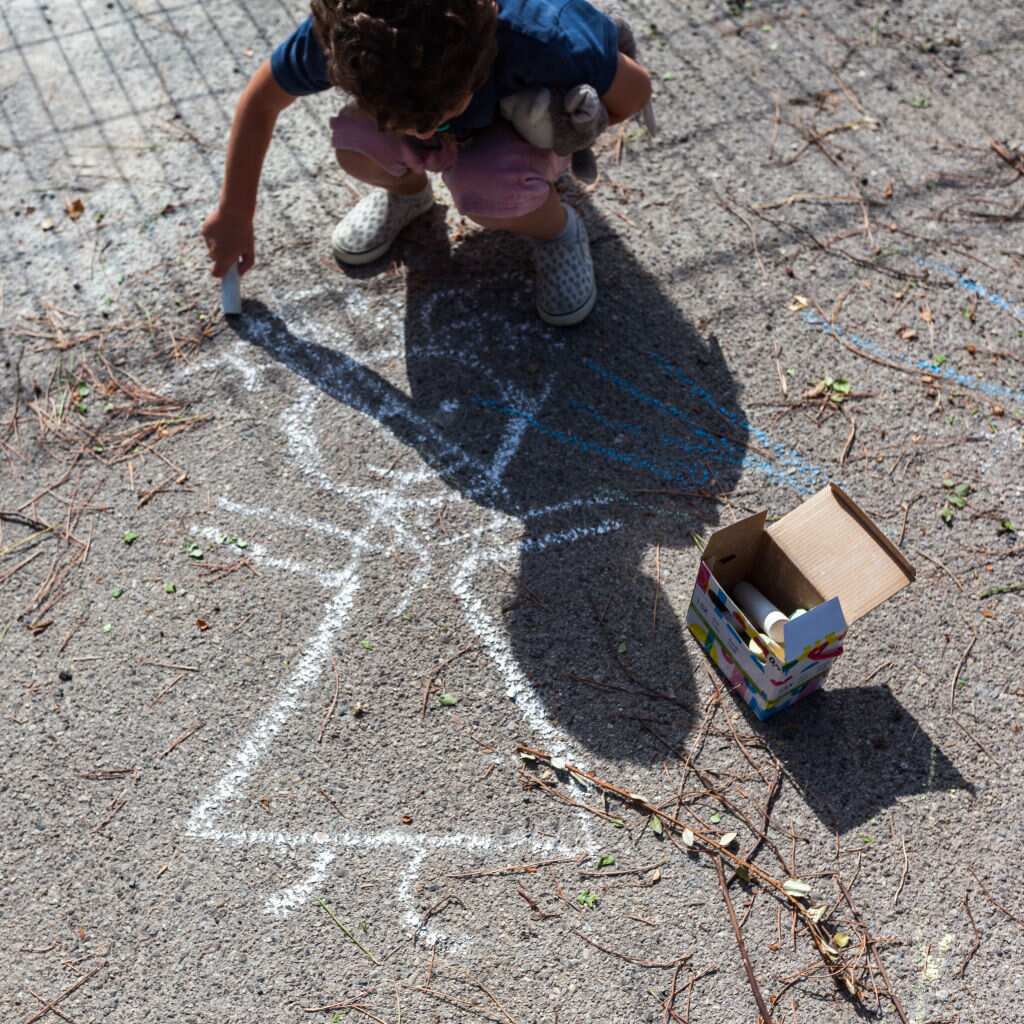 Child drawing with chalk