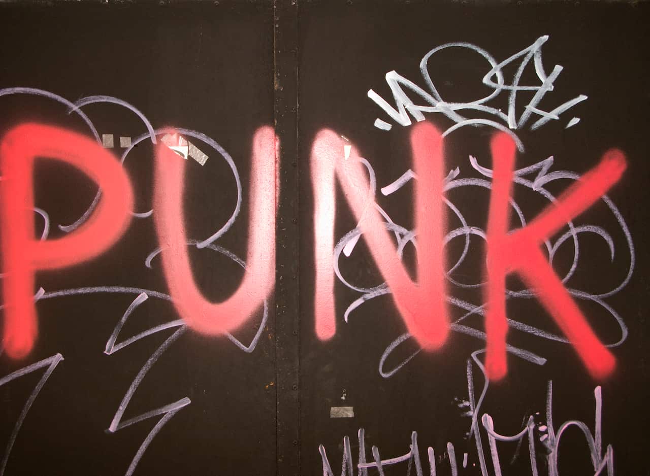 The word punk painted over graffiti