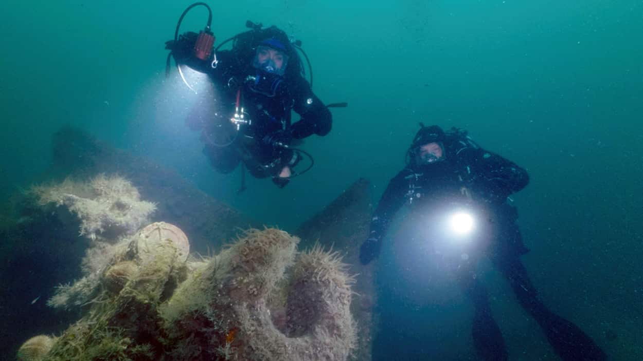 Ross Kemp and expert dive guide, Emily Turton, exploring the guns on the wreck of German WWI warship SMS Karlsruhe