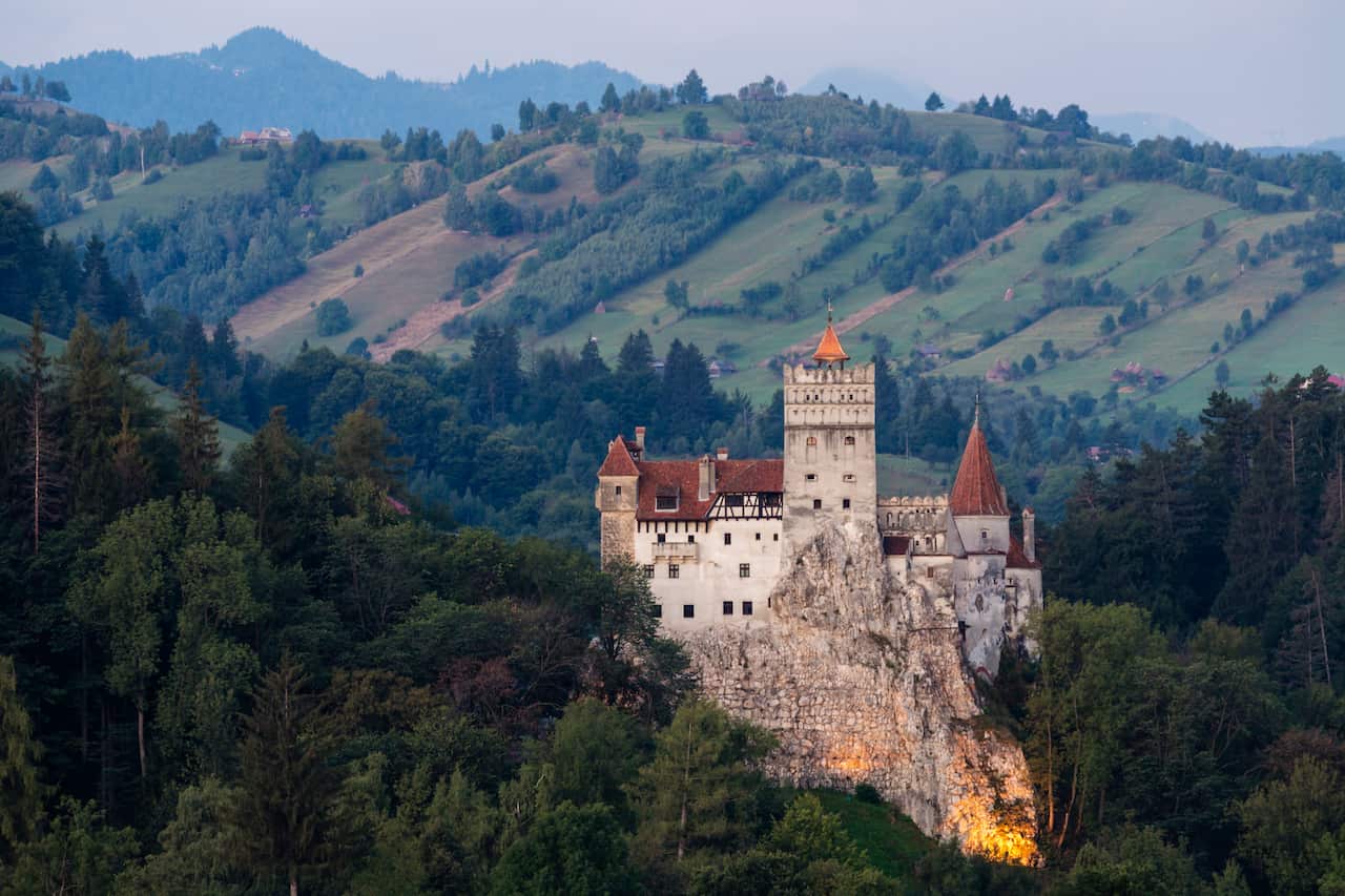 Bran Castle illuminated in rural landscape, Bran, Brasov, Romania