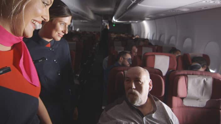 Qantas crew with passenger