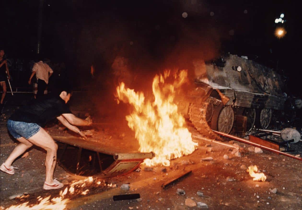Protesters clash with PLA armoured vehicles during the bloody night three decades ago. 