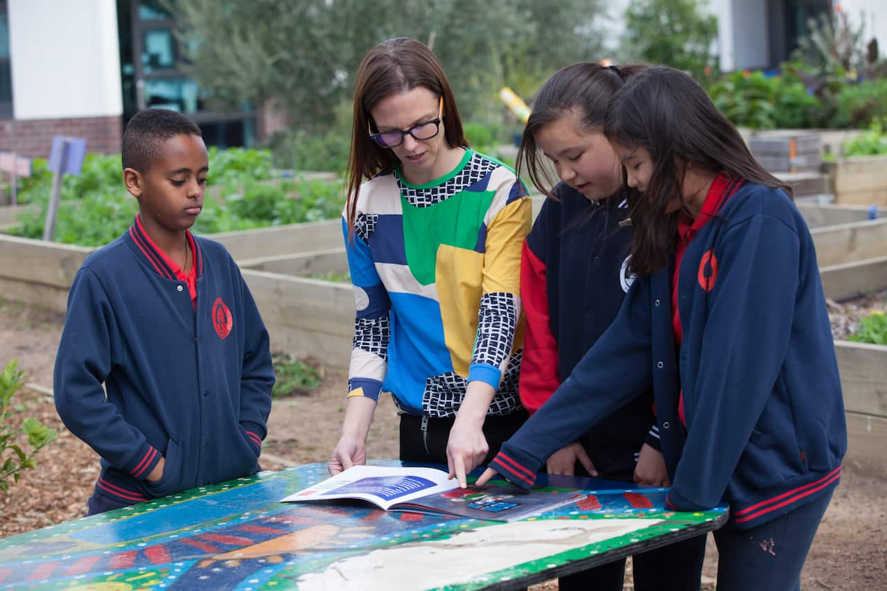 Monash resedarcher Mervi Kaukko with Noble Park Primary school students.