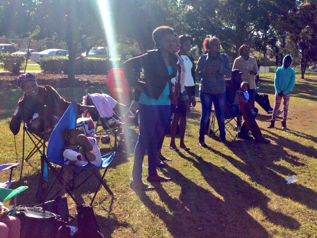 Friends and family watch the South Sudanese Youth Independence Cup in South Granville. (SBS)
