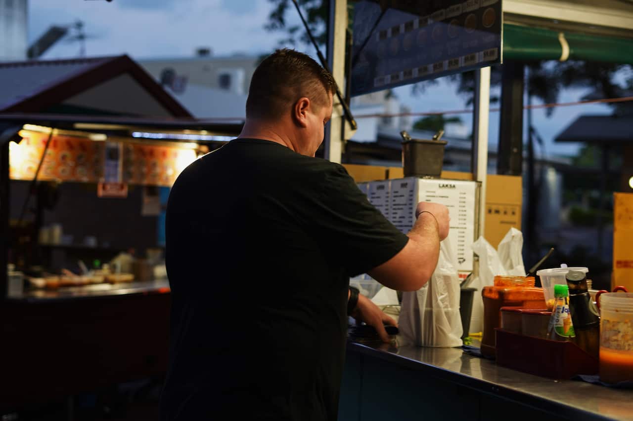 People line up each weekend from about 5am to get their hands on a steaming bowl of laksa.
