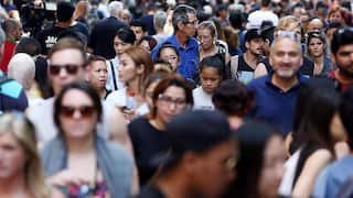 A crowded street with people walking.