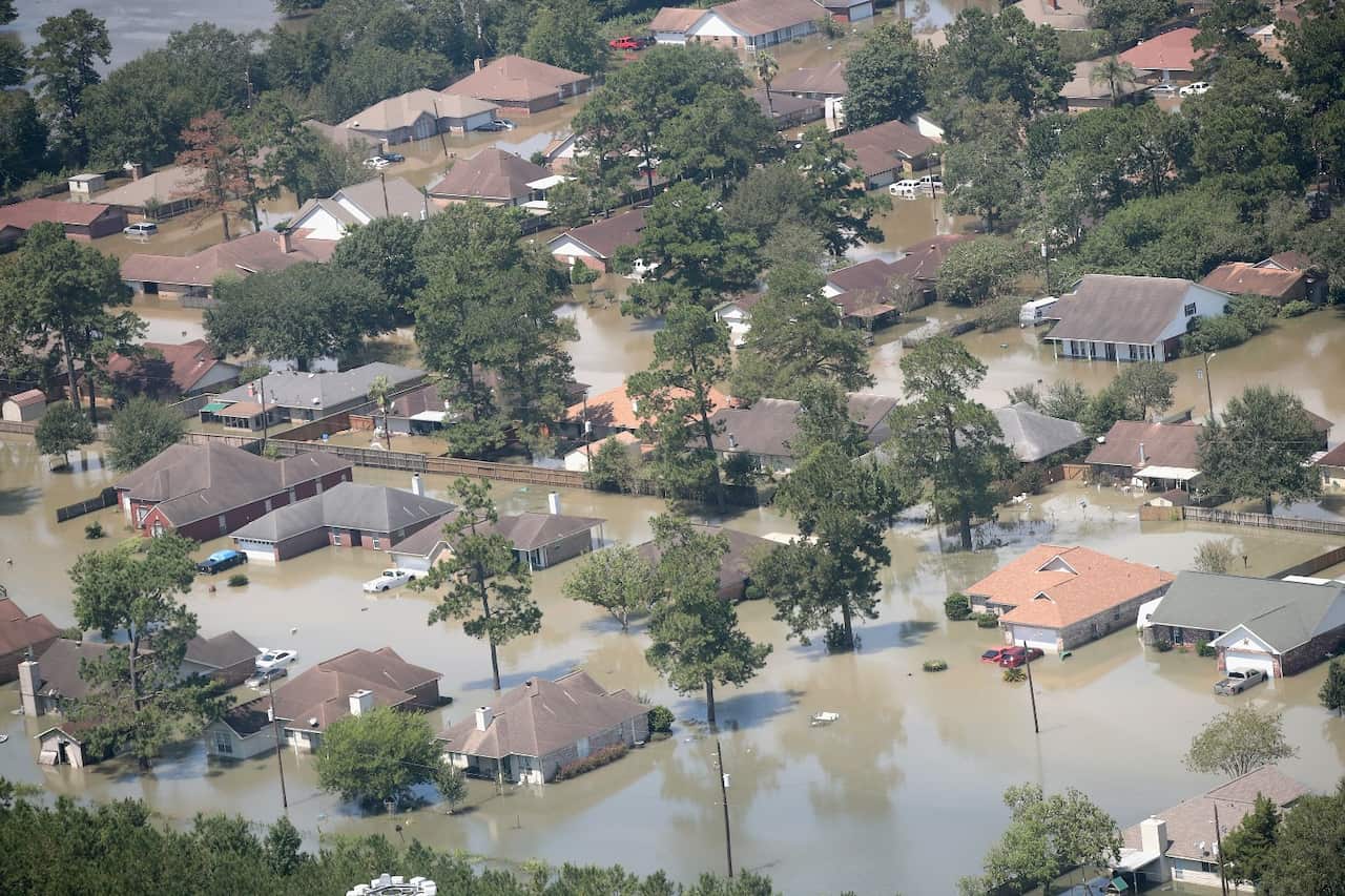 Homes are surrounded by floodwater after torrential rains pounded Southeast Texas following Hurricane and Tropical Storm Harvey