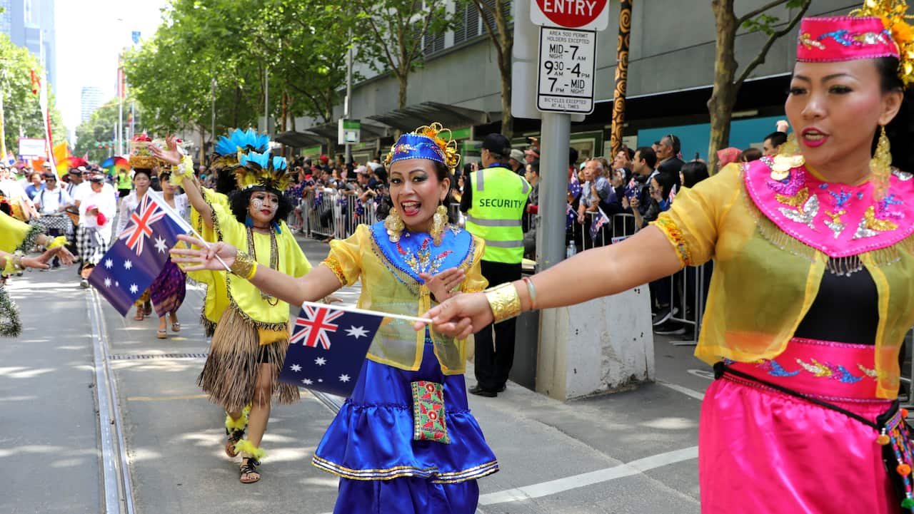 Participants sing and dance as part of Melbourne's Australia Day commemorations.