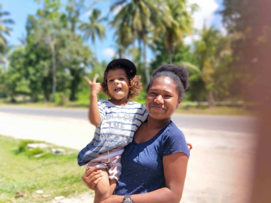 Mr Uddin's wife Alice holds the couple's young son. 