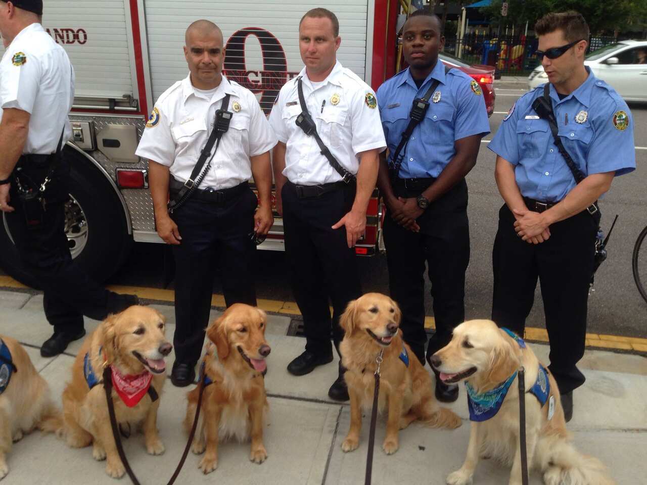 Orlando emergency services officers with dogs from the Lutheran Church Charities K-9 Comfort Dogs.