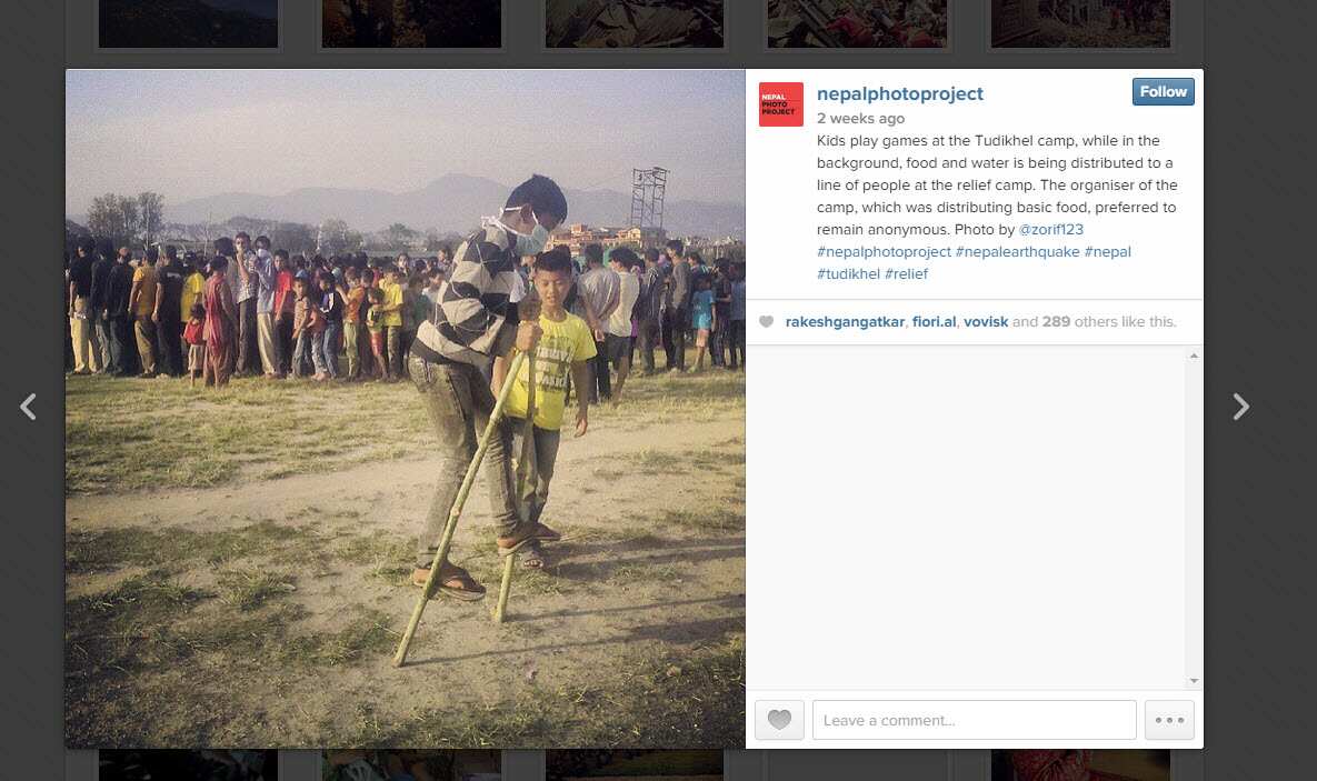 Kids play games at the Tudikhel camp, while in the background, food and water is being distributed to a line of people at the relief camp. Photo by @zorif123 Nepal Photo Project