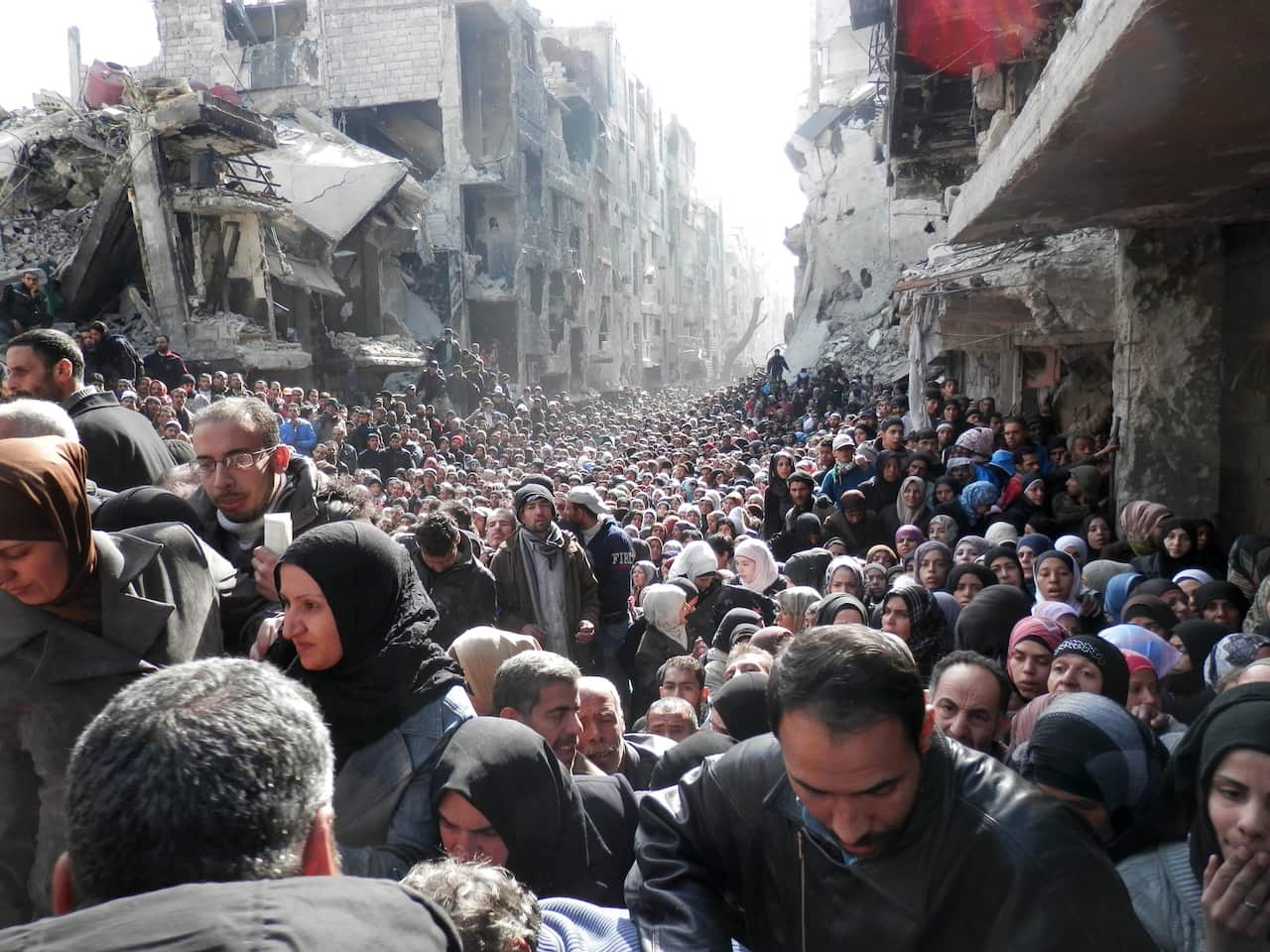 Residents of Syria's besieged Yarmuk Palestinian refugee camp, south of Damascus,
