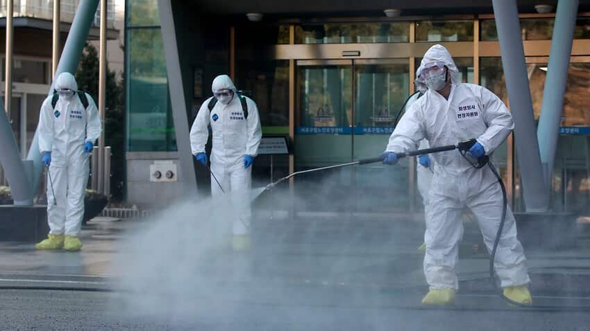South Korean soldiers wearing protective gear spray disinfectant as a precaution against the new coronavirus in Seoul, South Korea Source: AP