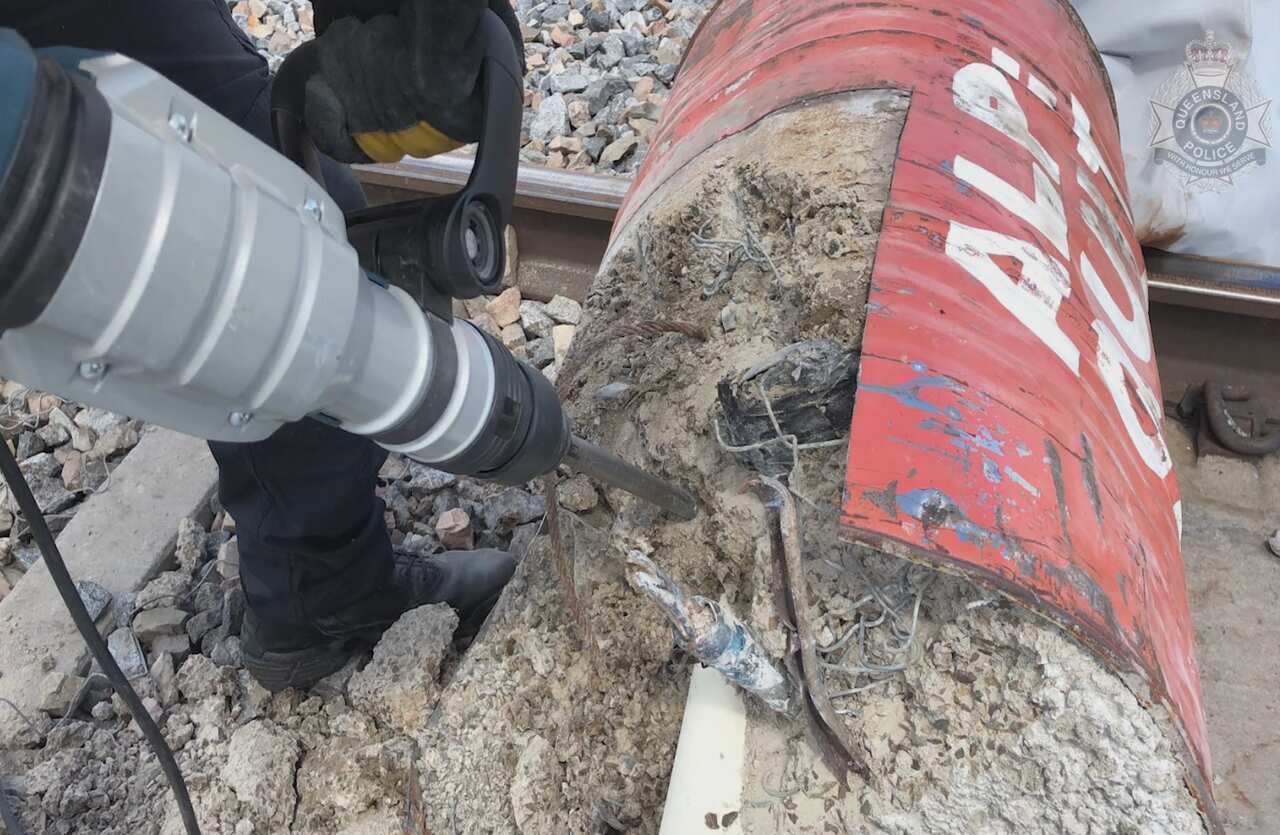 Police cutting open a dragon's den lock-on device