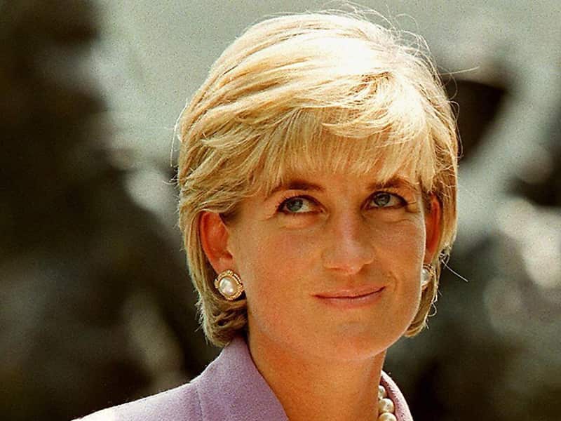 Princess Diana with short blonde hair smiling outside 