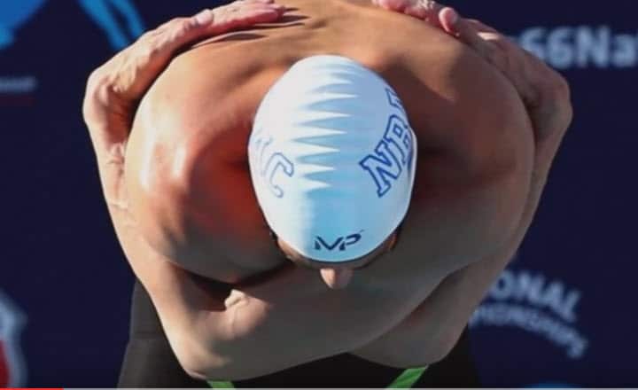 Michael Phelps draws attention for his pre-race stretch.