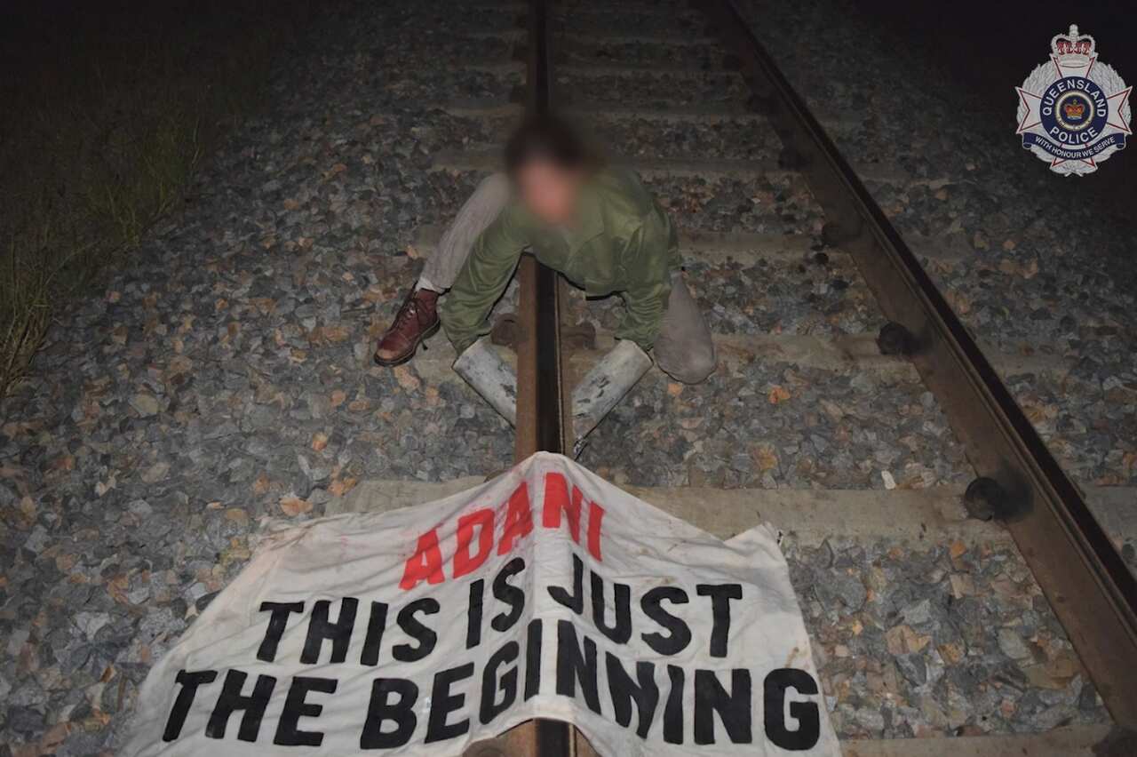 Anti-Adani protester using sleeping dragon lock-on device