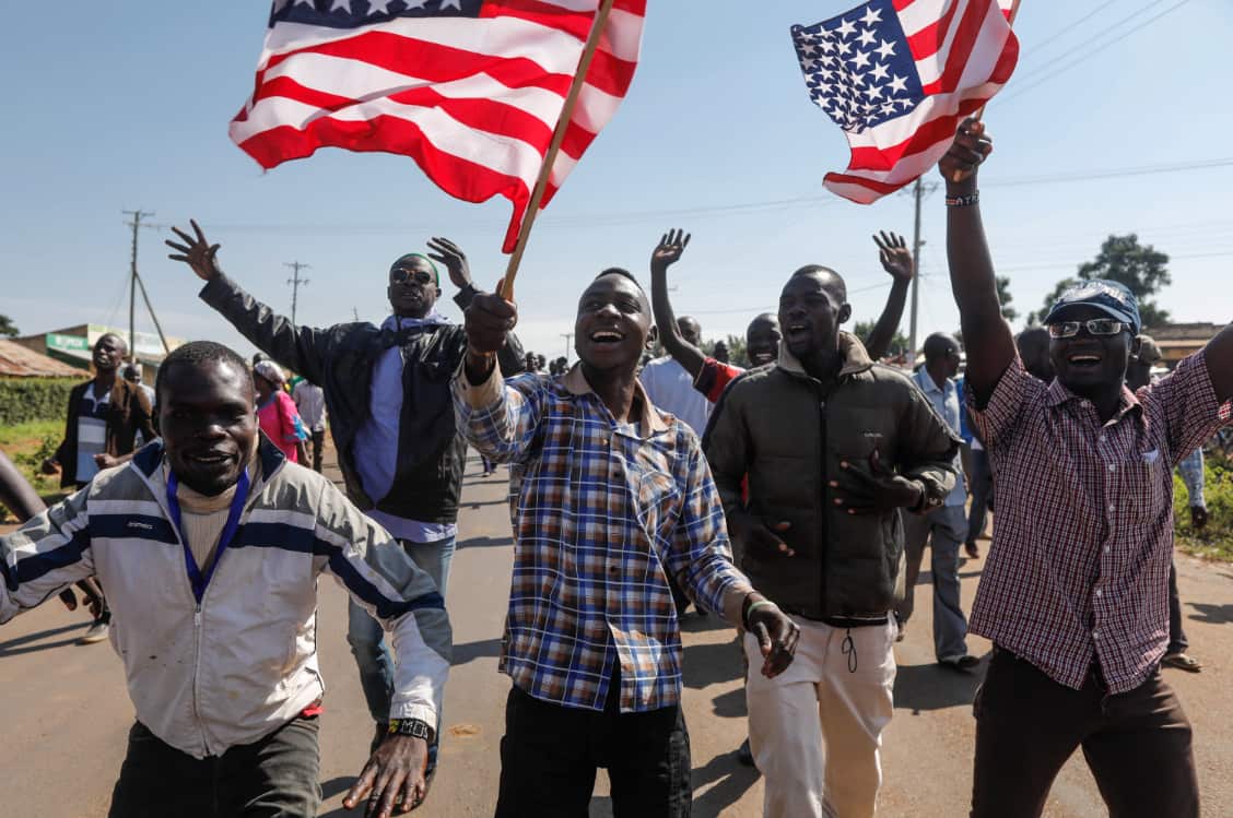 Supporters of former US president Barack Obama wave US flags in Kogelo, Kenya.