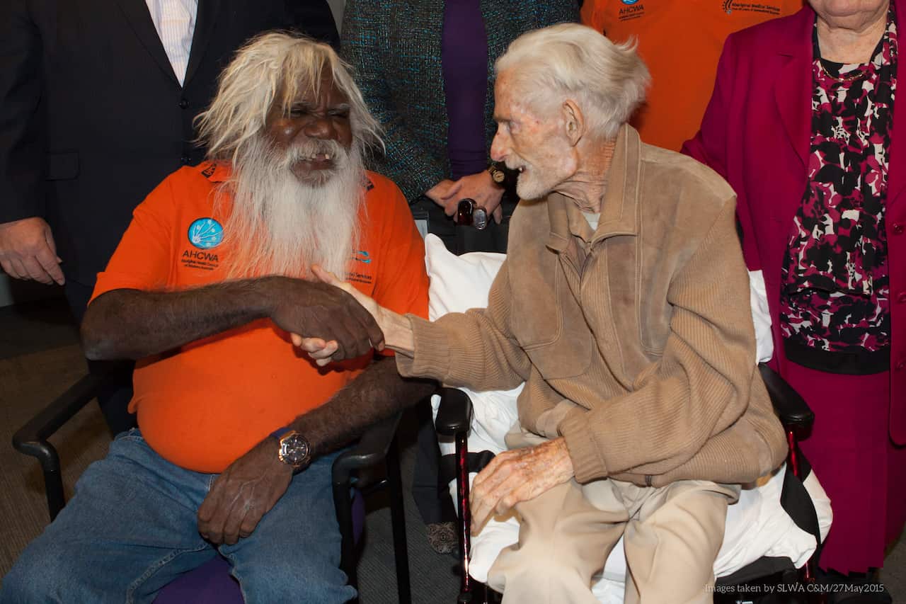 Bruce Thomas, Chair of the Wangka Maya’s Board of Directors, shakes hands with John Hutchinson in May 2015