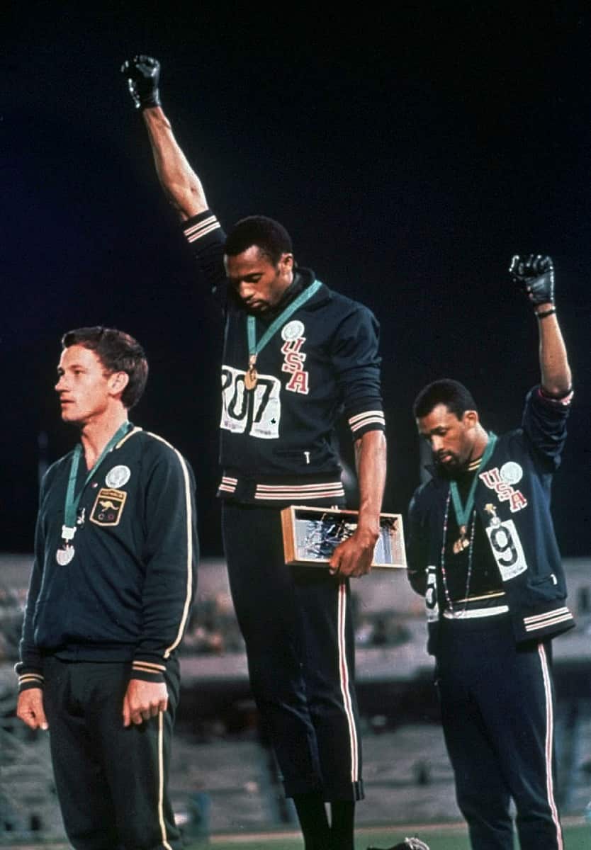 Tommie Smith (centre) and John Carlos raise their gloved fists on the podium after the 200-metre run event at the 1968 Olympics.