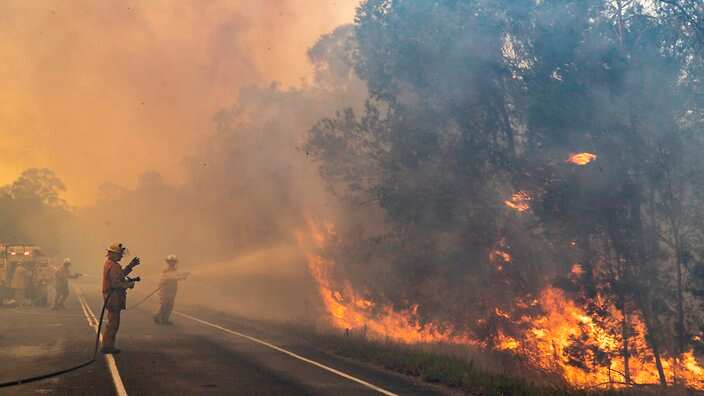 Queensland is bracing for hot and dry winds as NSW fires are set to cross the northern border on Wednesday.