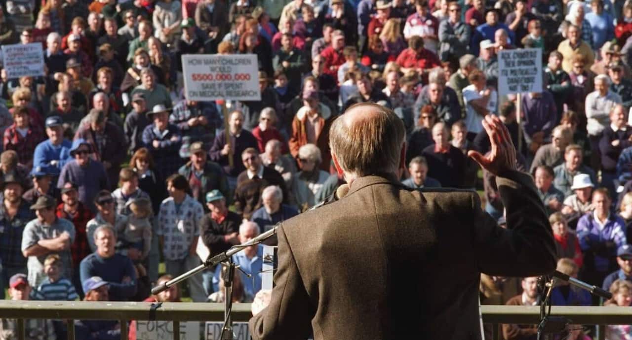 John Howard wears a bulletproof vest in 1996.