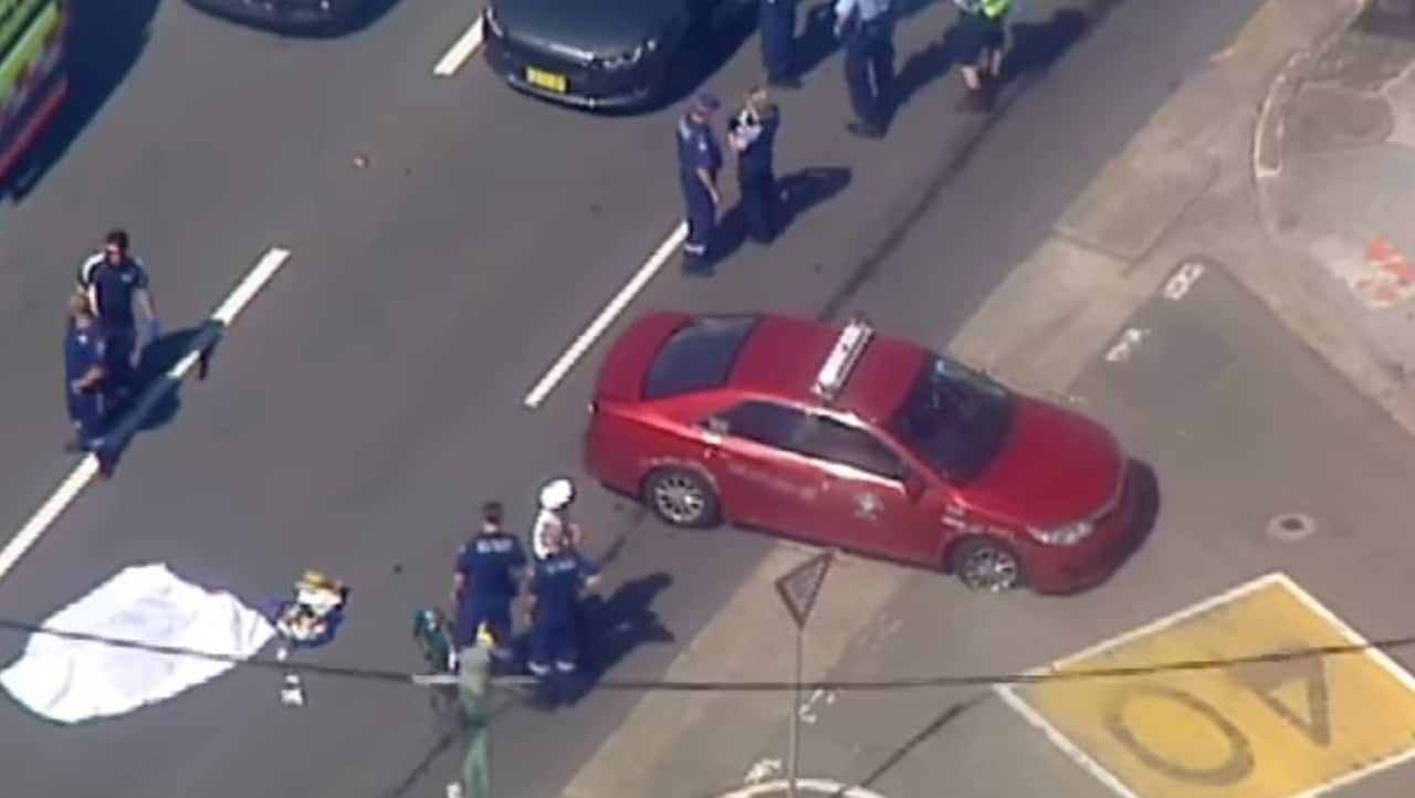 A red taxi at the scene.