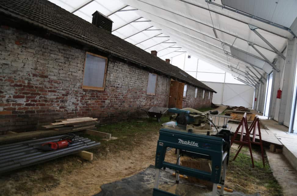 Conservation crews restore Birkeanu Barracks Block 7, in former camp BIb.