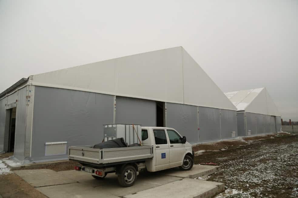 Aluminum tents protect conservation teams working to restore the Birkenau barracks.