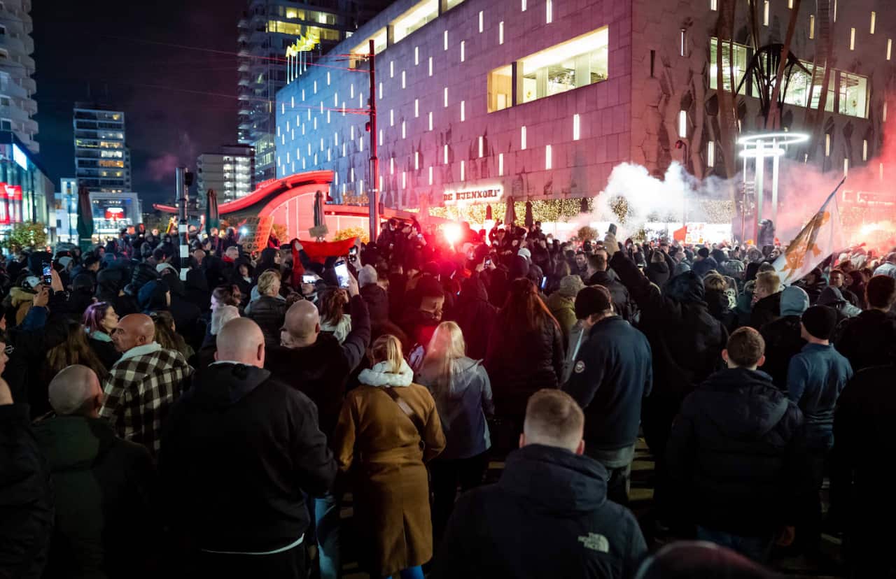 Hundreds of people gather during a protest against COVID-19 restrictions in Rotterdam, Netherlands, 19 November 2021.