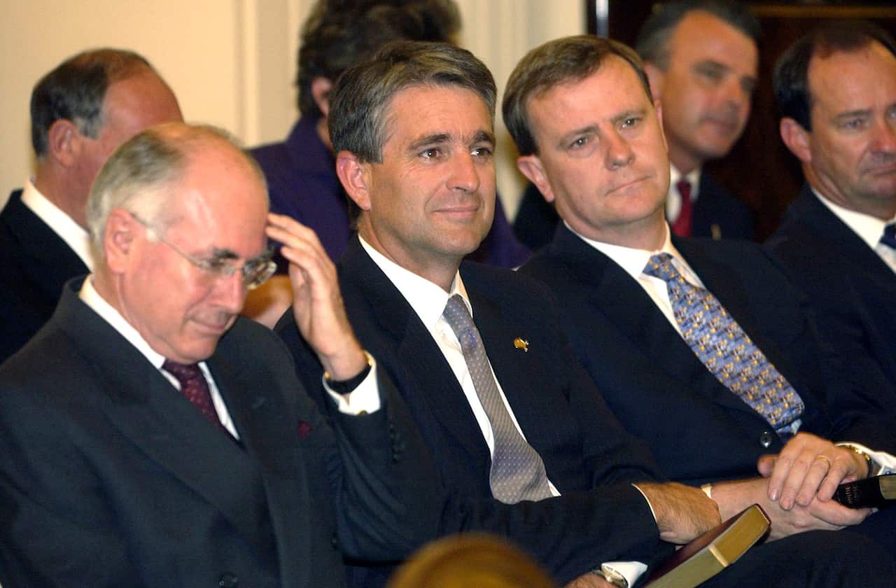 PM John Howard,Deputy PM John Anderson & Treasurer Peter Costello during the Swearing-In ceremony of Ministers at Government House Canberra today.  (AAP Image/Alan Porritt) NO ARCHIVING