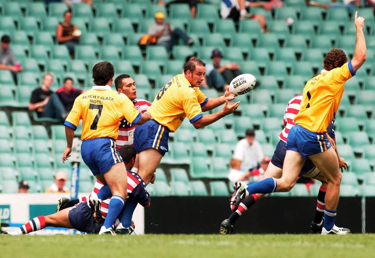 Coogee Dolphins Mark Geyer flicks a pass off to Brett Mullins during their exhibition match against the USA in the World Sevens Rugby League tournament.