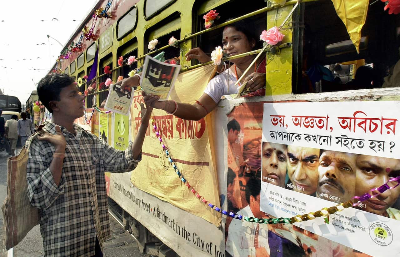 An Indian sex-worker distributes AIDS-preventive leaflets from a decorated tramway as a part of campaign against AIDS in Calcutta (AFP)