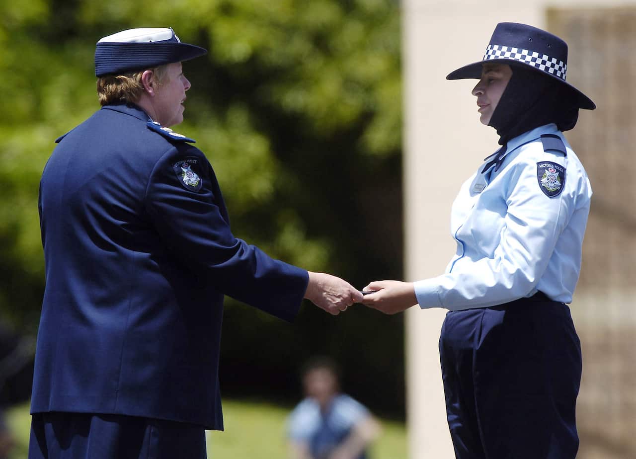 2004 - Police recruit Maha Sukkar receives her badge from Police Commissioner Christine Nixon